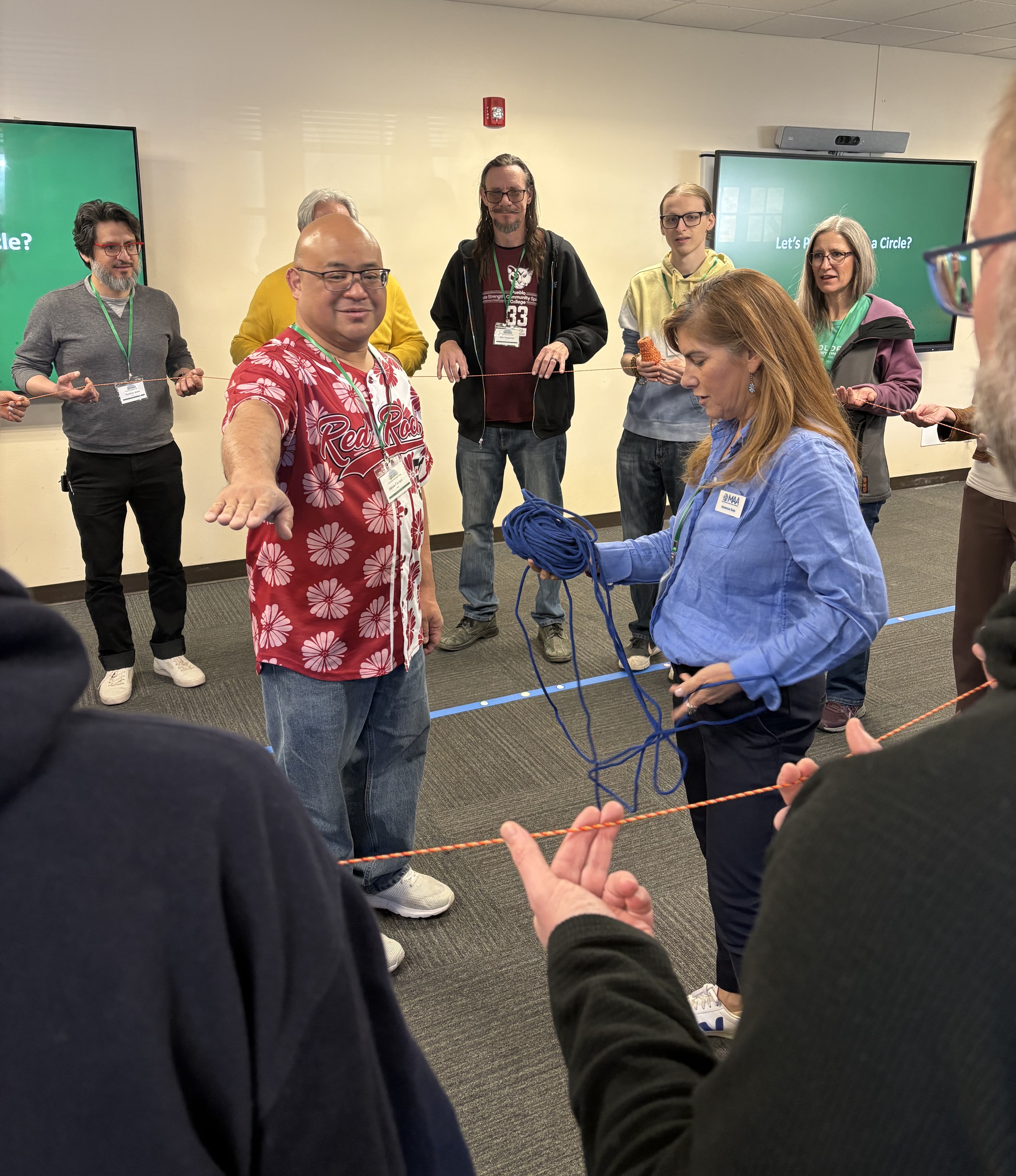 Photo of math educators trying to make a perfect circle with string.